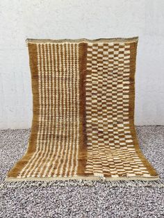 a brown and white rug sitting on top of a floor