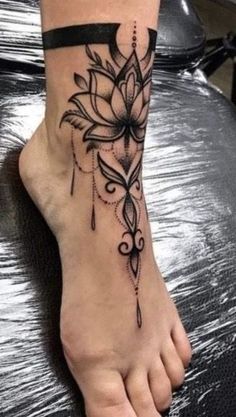 a woman's foot with a flower tattoo on it