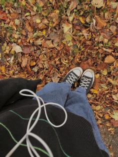 a person with their feet up in the leaves