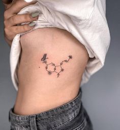 a woman's lower back tattoo is shown