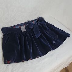 Nwt Abercrombie & Fitch Navy Velvet Mini Skirt. Gathered At Waist For Flattering Fit. 2 Front Side Pockets. Cute Sash Tie Detail. Side Zipper. Size 10 Waist 17.5 Length 14 Vegan Leather Midi Skirt, Brown Leather Skirt, Flowy Maxi Skirts, Maxi Lace Skirt, Velvet Mini Skirt, Ruffle Mini Skirt, Distressed Denim Skirt, Jean Mini Skirts, Leather Midi Skirt