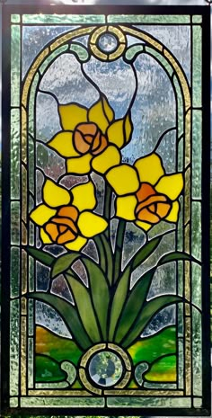 a stained glass window with yellow flowers in it