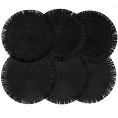 four round black placemats with fringe on each side and one in the middle