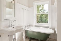 a bathroom with a claw foot tub and sink