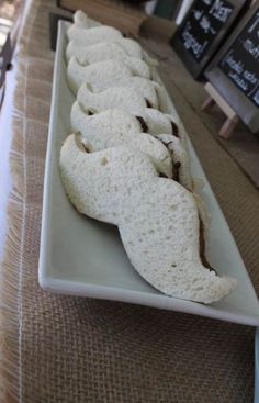 several pieces of bread on a long white plate