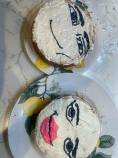 two cakes decorated with faces are on plates