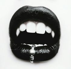 an open mouth with white teeth and black lipstick