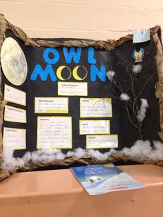 an owl moon bulletin board is displayed on a table