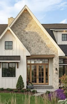 a white house with stone and wood accents