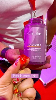 a woman holding a bottle of nutriplus focus core in her hand with the label on it