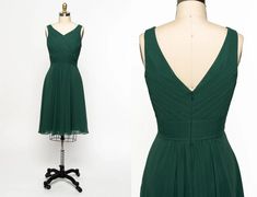 a green dress on a mannequin with the back cut out to look like it is