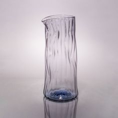 a glass vase sitting on top of a table