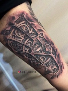 a man's leg with an intricate tattoo on it