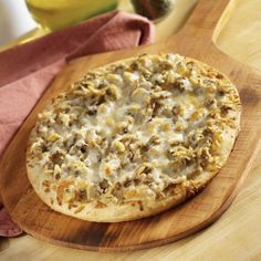 a pizza sitting on top of a wooden cutting board