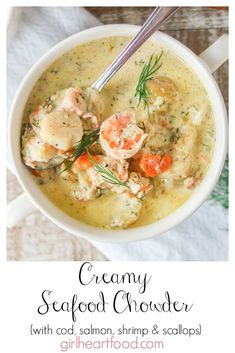 creamy seafood chowder with carrots, shrimp and scallops in a white bowl