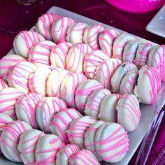 pink and white striped candy balls on a plate with the caption pint to win