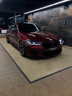 a maroon car parked in a parking garage