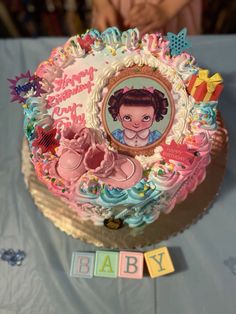 a birthday cake for a baby girl on a table