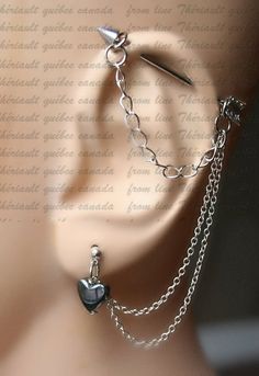 a close up of a mannequin's head with chain and heart charms on it