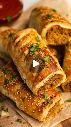 several pieces of bread on a cutting board with herbs sprinkled all over them