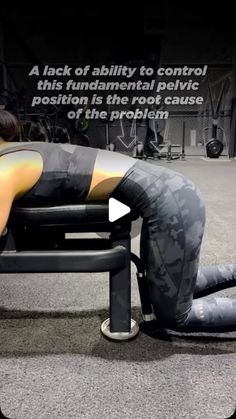 a woman is sitting on a bench with her back to the camera