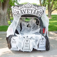 a car decorated for halloween with graveyard decorations