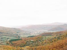 an aerial view of mountains and valleys in autumn