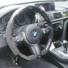 the interior of a car with steering wheel and dashboard