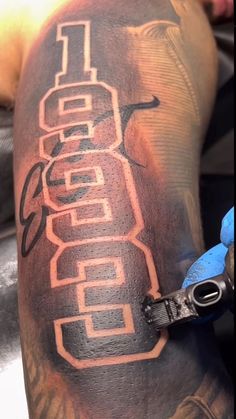 a man with a tattoo on his arm that has the word denver painted on it