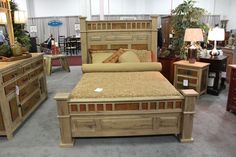 a bed room with a neatly made bed and lots of furniture on the floor in front of it