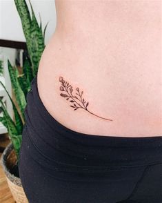 a woman's stomach with a small tattoo on it