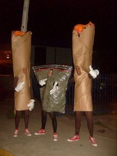 two people dressed in costumes standing next to each other with bags on their heads and hands