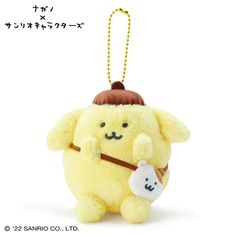 a yellow stuffed animal with a brown hat on it's head holding a small white teddy bear