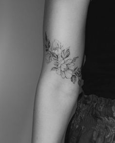 a woman with a flower tattoo on her arm