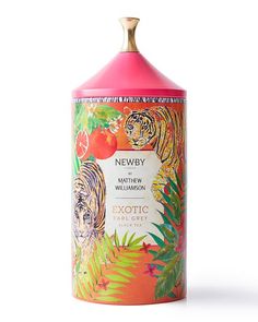 a pink bottle with an orange and white tiger on it's lid sitting in front of a white background