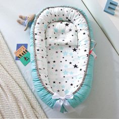 a baby's bassinet is laying on the floor next to a stuffed animal