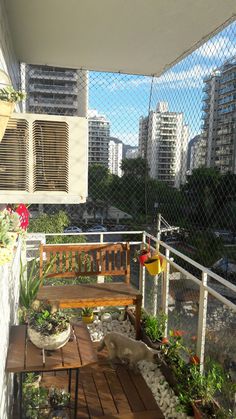 a wooden bench sitting on top of a balcony