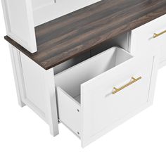 a white and wood desk with two drawers on it's side, next to a wooden counter top