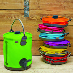 several different colored coolers sitting next to each other on a wooden floor with a wall in the background