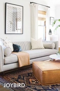 a living room filled with furniture and plants