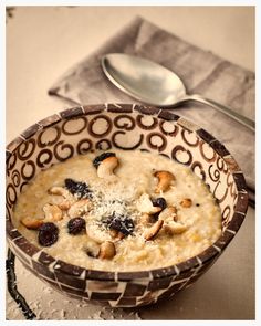 a bowl of oatmeal with nuts and raisins