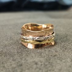 "Benefits Of Spinner Ring ---------------------------------------------- A spinner ring is a ring that you wear on your finger, usually silver, that has an inner band locked in place that can be spun while the rest of the ring stays in one place on your finger. The spinner ring is believed to come from ancient Tibetan meditation traditions, and is called a \"worry ring\" because spinning the right is believed to have a calming effect on the mind and body. While some spinner ring supporters argue Spinner Rings Tutorial, Spinner Rings Womens, Tibetan Meditation, Thea Queen, Spinning Ring, Spinning Rings, Worry Ring, School Jewelry, Fidget Rings