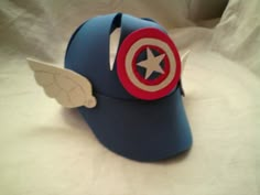 the captain's cap is made out of paper and has wings on it,