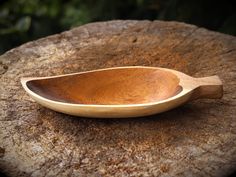 a wooden spoon sitting on top of a rock