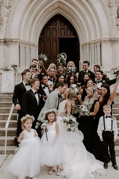 a large group of people standing in front of a church