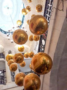 some shiny gold balls hanging from the ceiling