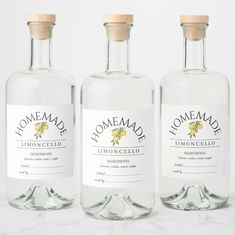 three bottles of lemoncello on a marble surface