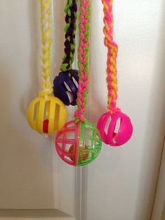 several different colored toys hanging from a door