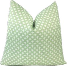 a green and white pillow on a white background