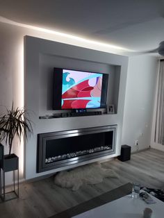 a flat screen tv mounted on the wall above a fireplace